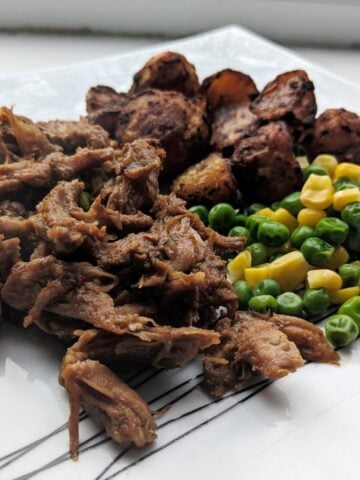sticky pulled pork with potato, green peas and sweet corns