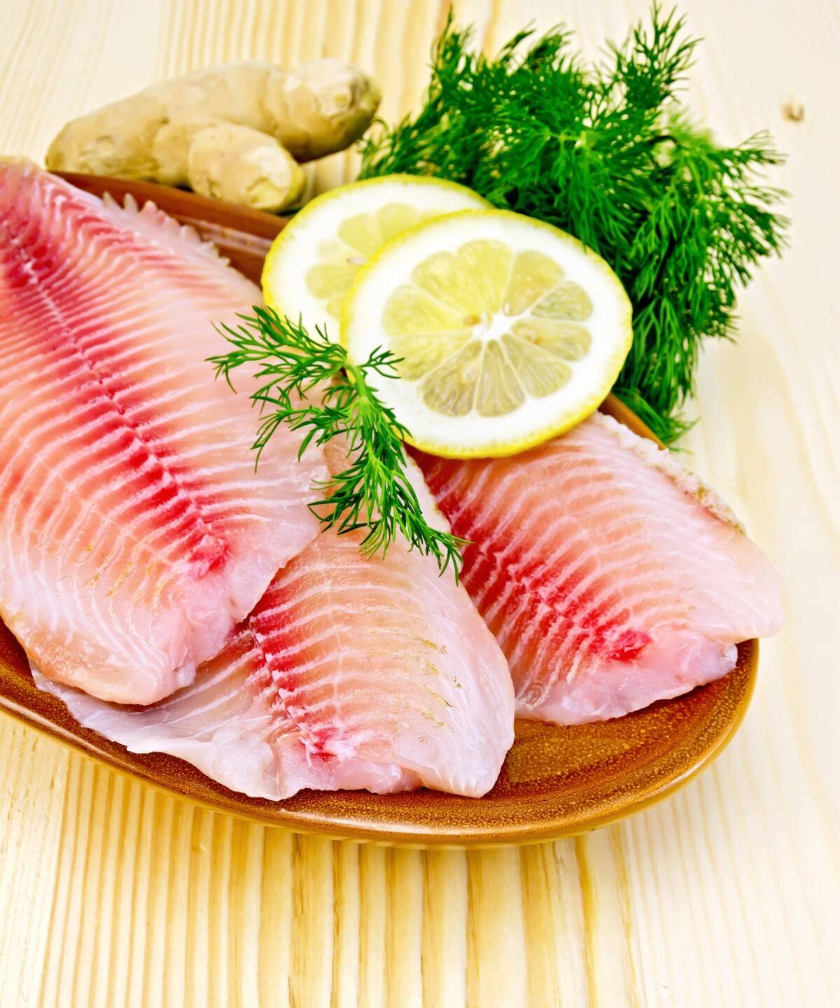 tilapia fillets with lemon and dill in pottery