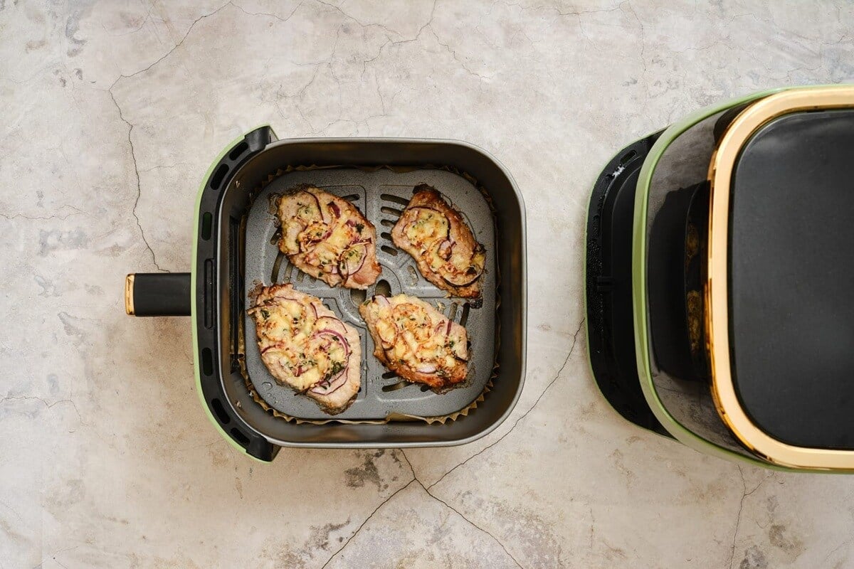 pork chops cooking in an air fryer