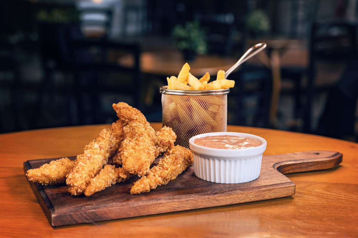 frieds chicken breast stripes with sauce and French fries