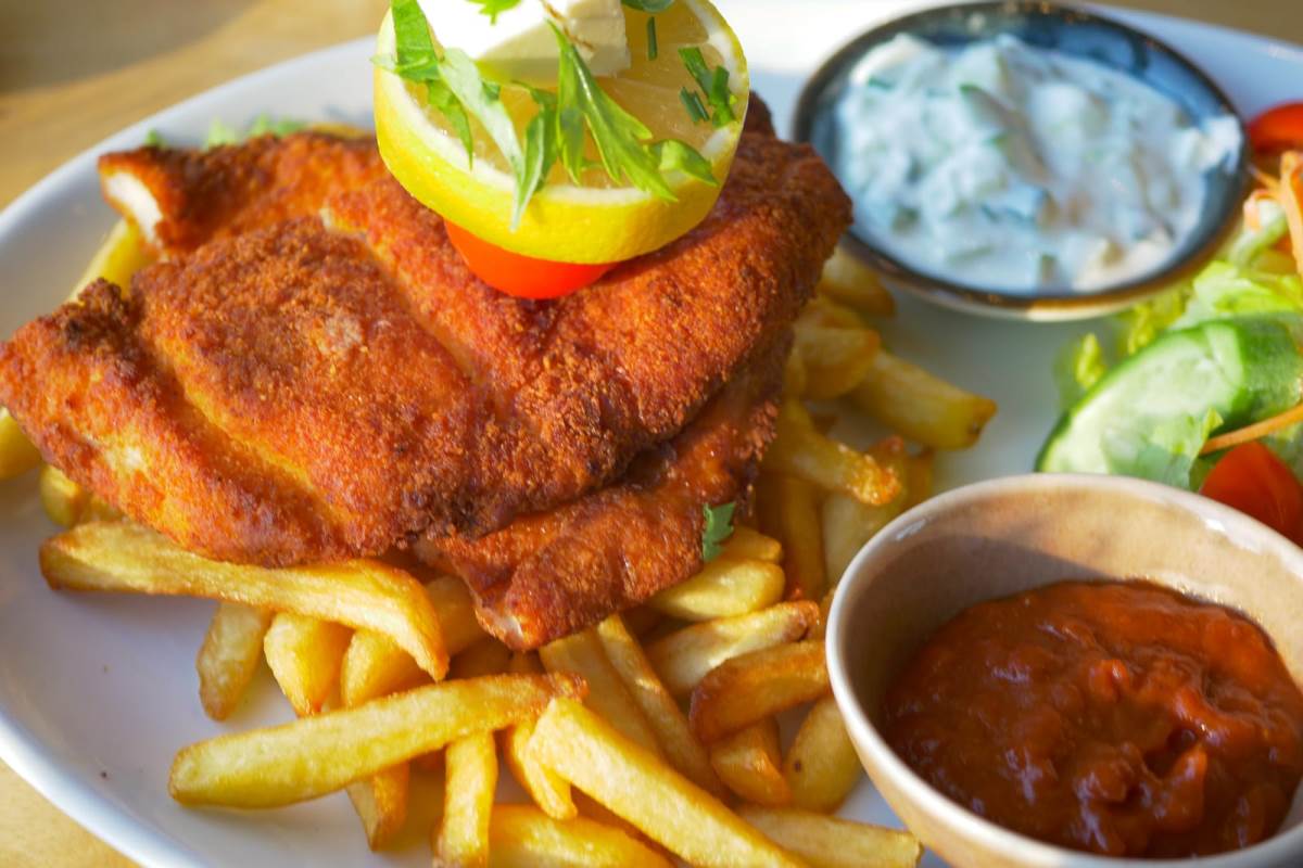 chicken schnitzel served with potato chips