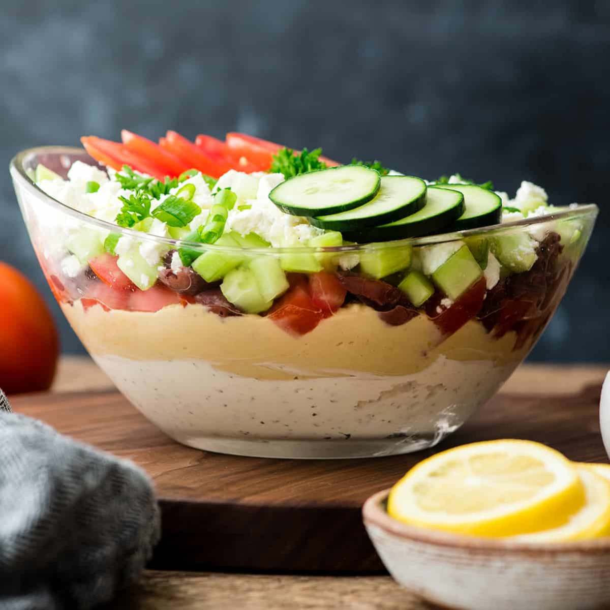  A layered Mediterranean dip in a glass bowl. 