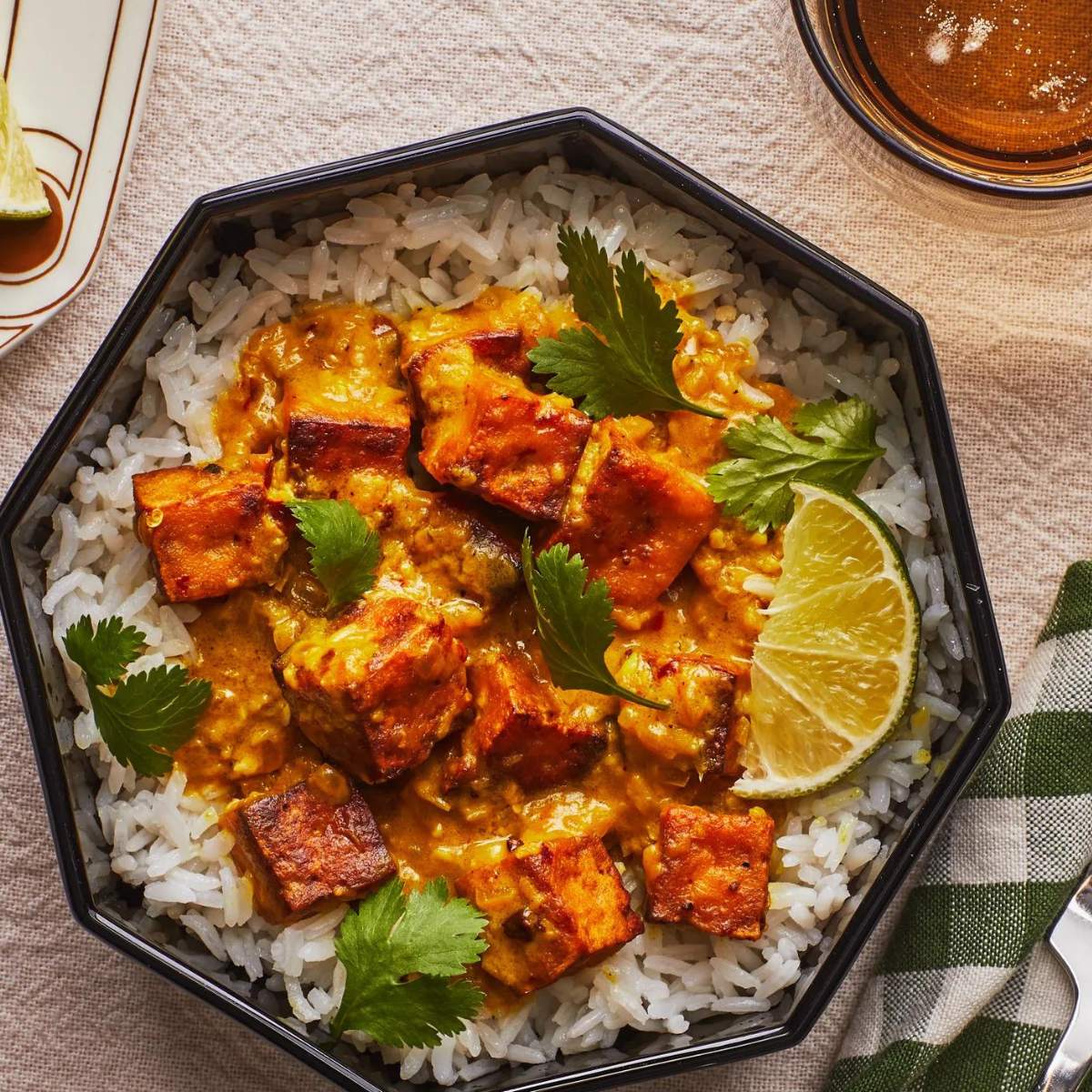  Crispy tofu served in a rich, yellow curry sauce. The tofu is pan-fried until golden brown and is topped with fresh cilantro. 