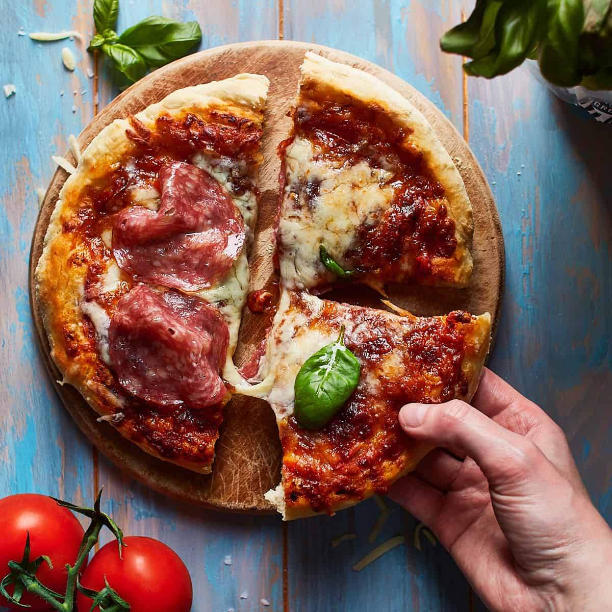 A delicious, homemade pizza with a crispy crust, topped with tomato sauce, cheese, and salami. 