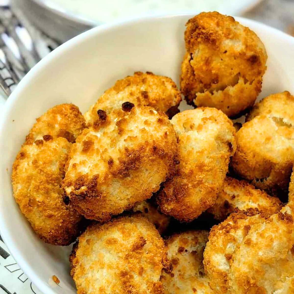 A bowl of golden brown, crispy chicken nuggets.