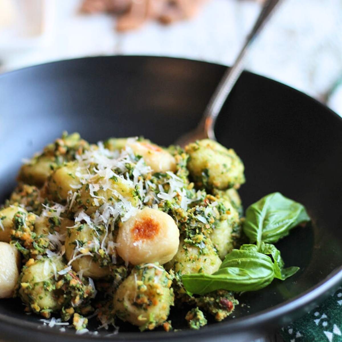  A bowl of gnocchi topped with a green almon