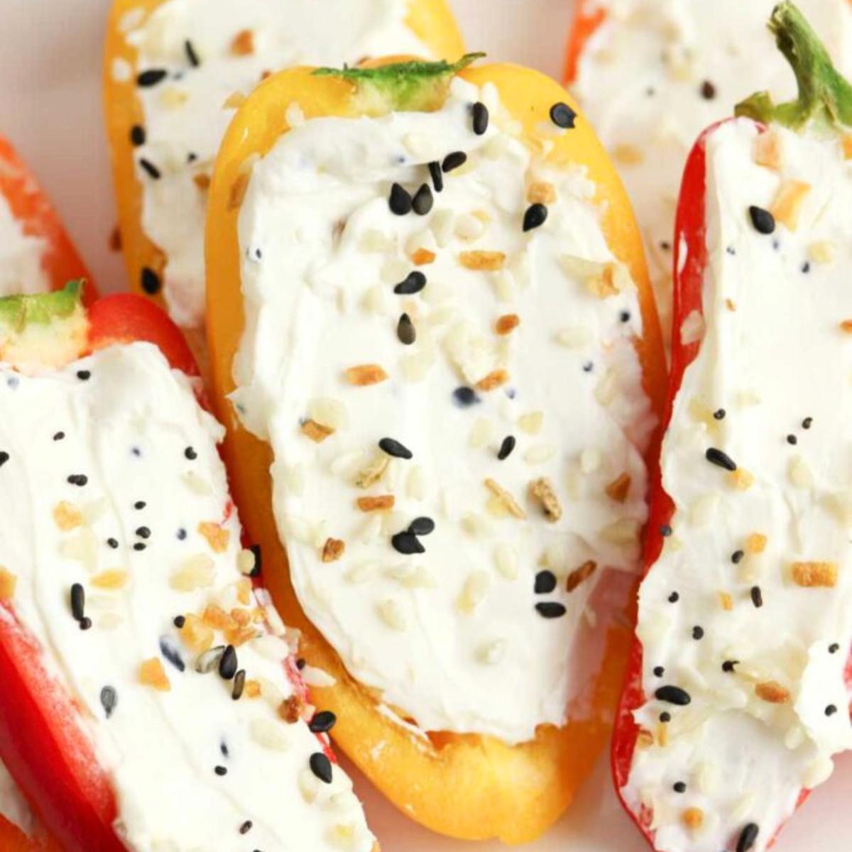  Baked mini peppers stuffed with cream cheese and topped with sesame seeds.