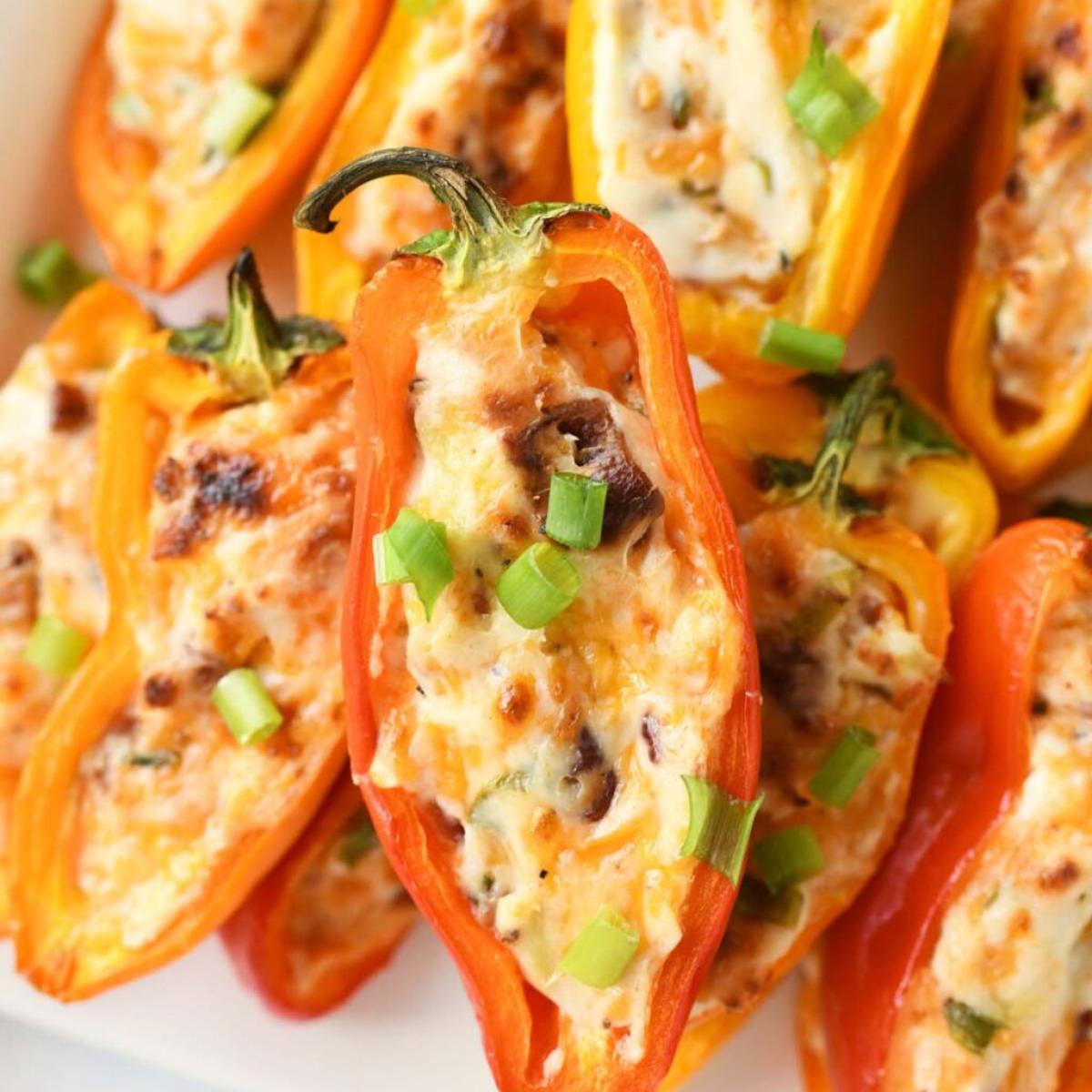  Baked mini peppers stuffed with a creamy cheese and bacon mixture, topped with chopped green onions.