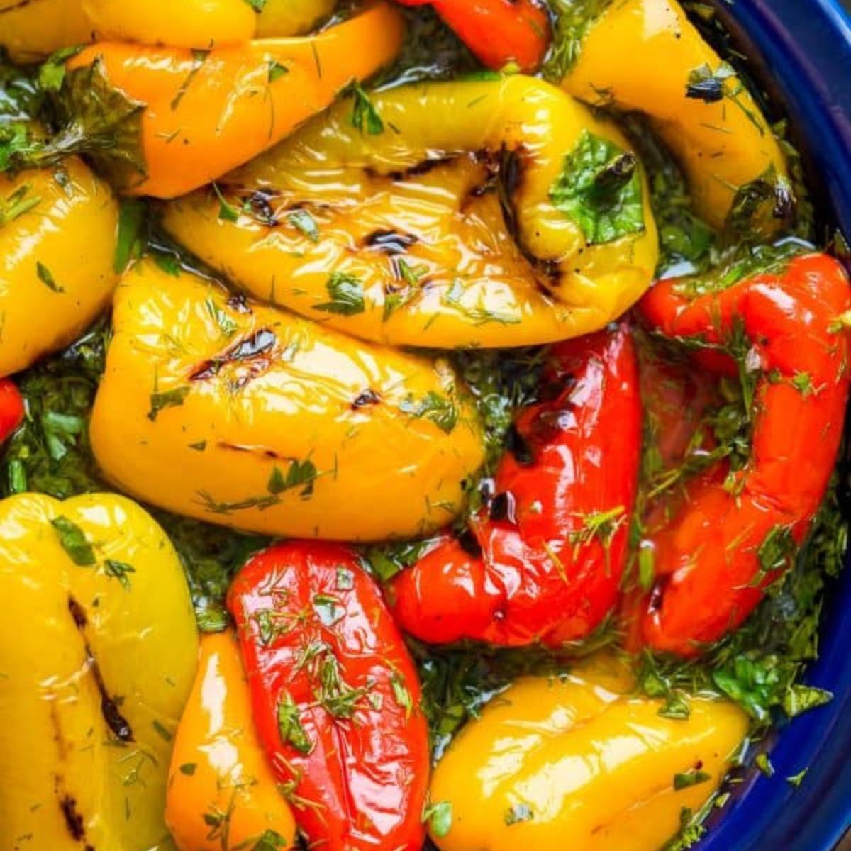 Grilled red and yellow mini peppers marinated in herbs and olive oil.