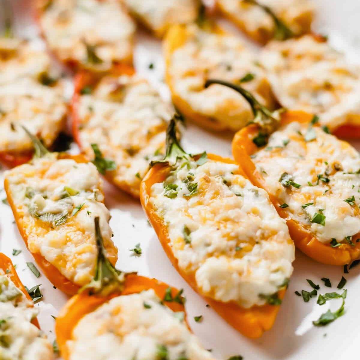  Baked mini peppers filled with a creamy cheese mixture, topped with fresh herbs.