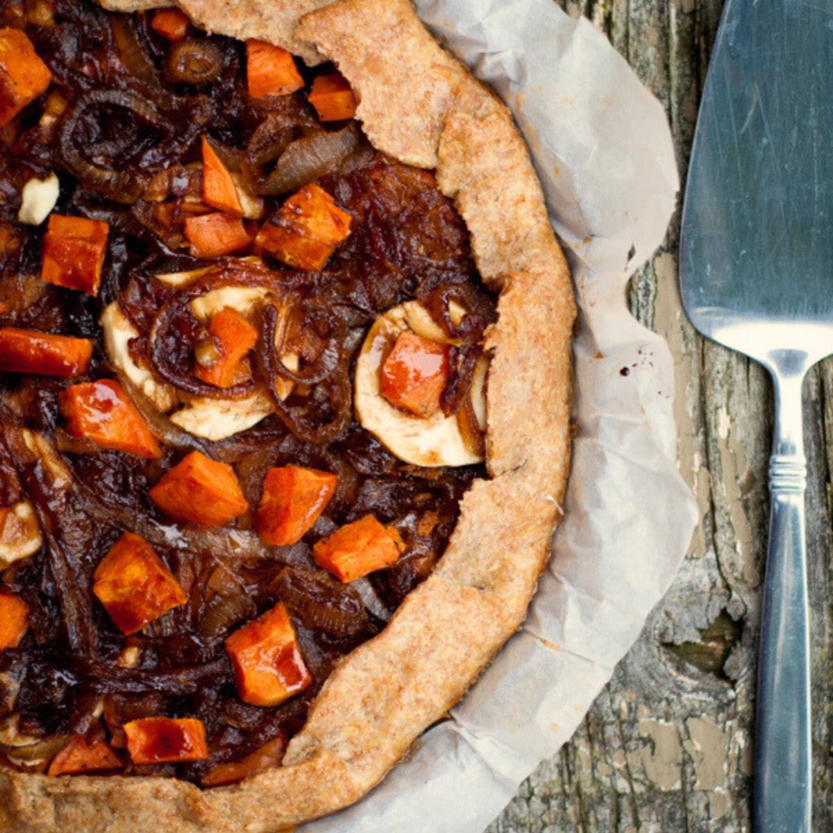 A rustic tart filled with caramelized onions, sweet potatoes, and apples.