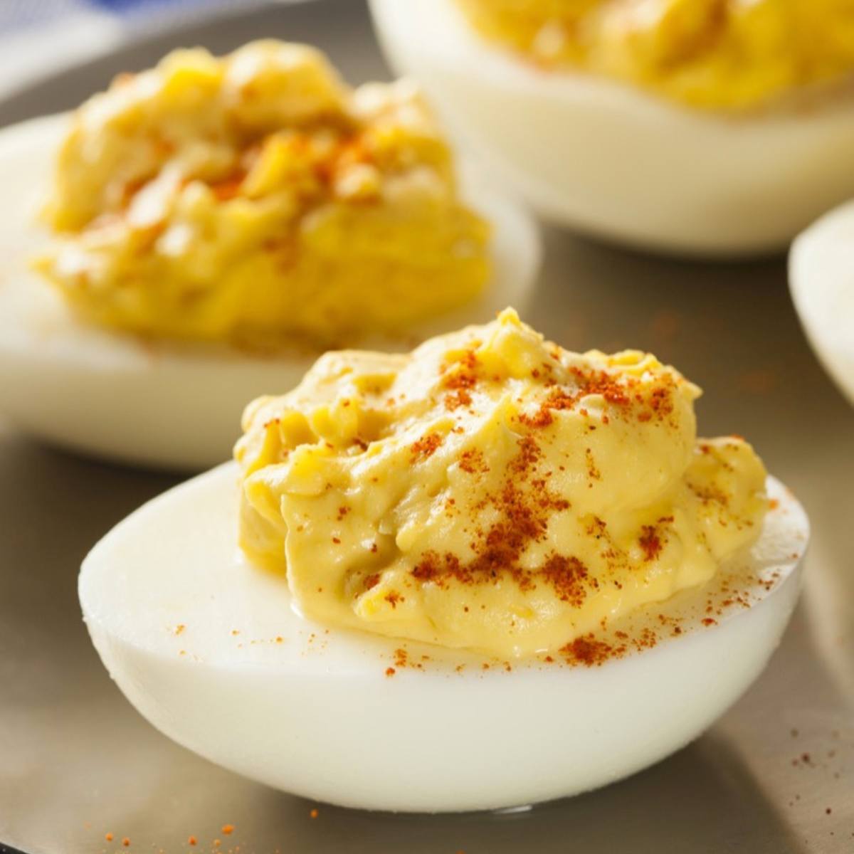 A close-up of deviled eggs with a sprinkle of paprika on top.