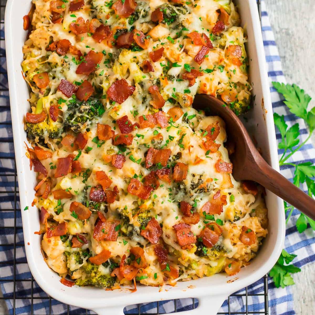 A casserole dish filled with a cheesy, creamy mixture of broccoli, white beans, and crispy bacon.