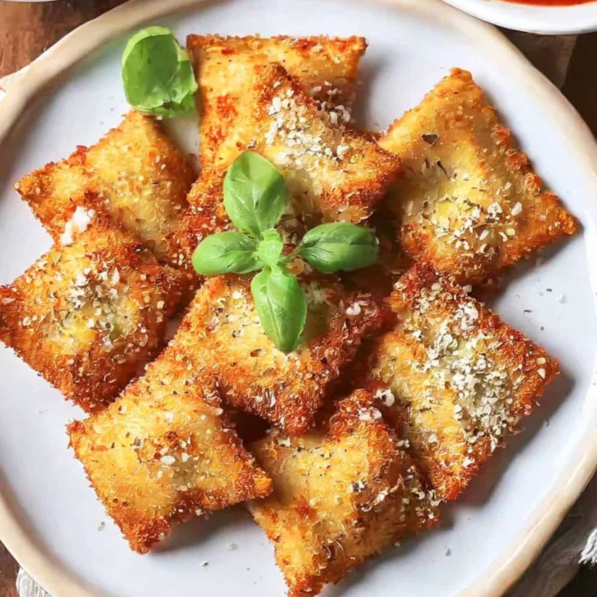 A plate of crispy, golden-brown fried ravioli.