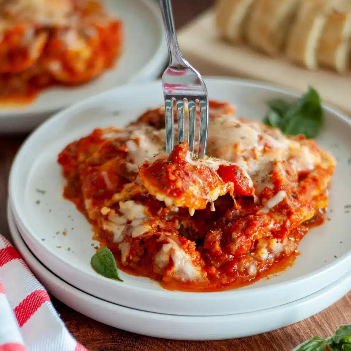 A fork lifting a piece of cheesy lasagna from a plate. The lasagna is layered with pasta, meat sauce, and melted cheese. It looks rich, hearty, and incredibly delicious.