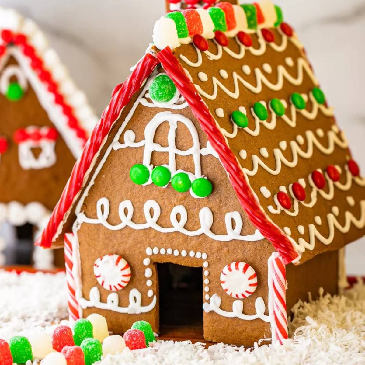 A charming gingerbread house with a candy roof, decorated with icing and colorful candies.