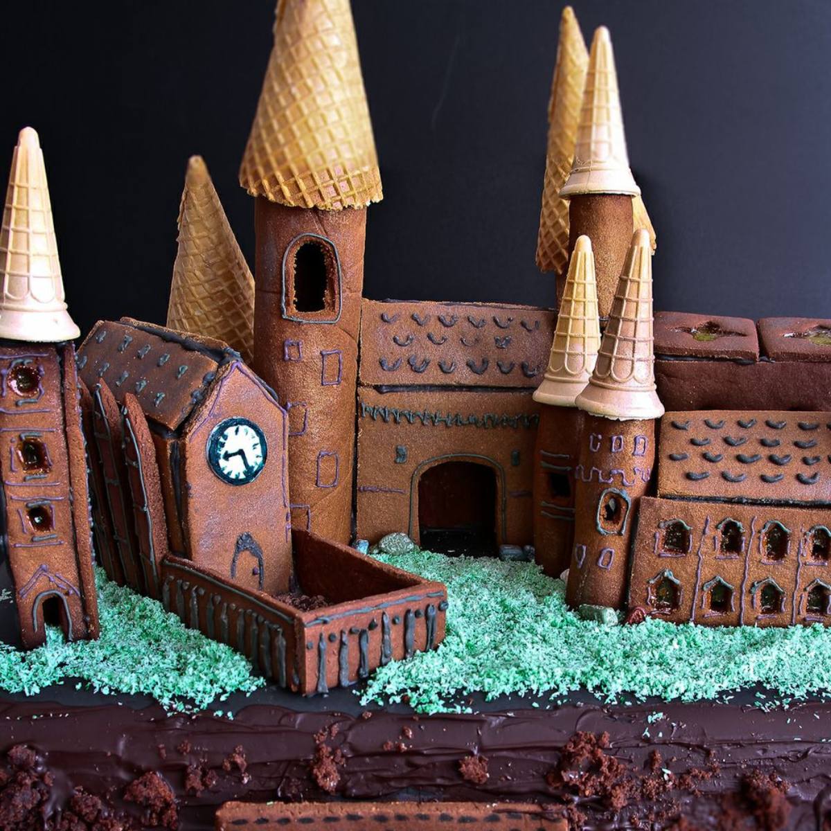 A detailed gingerbread replica of Hogwarts School of Witchcraft and Wizardry, complete with towers and a clock tower.