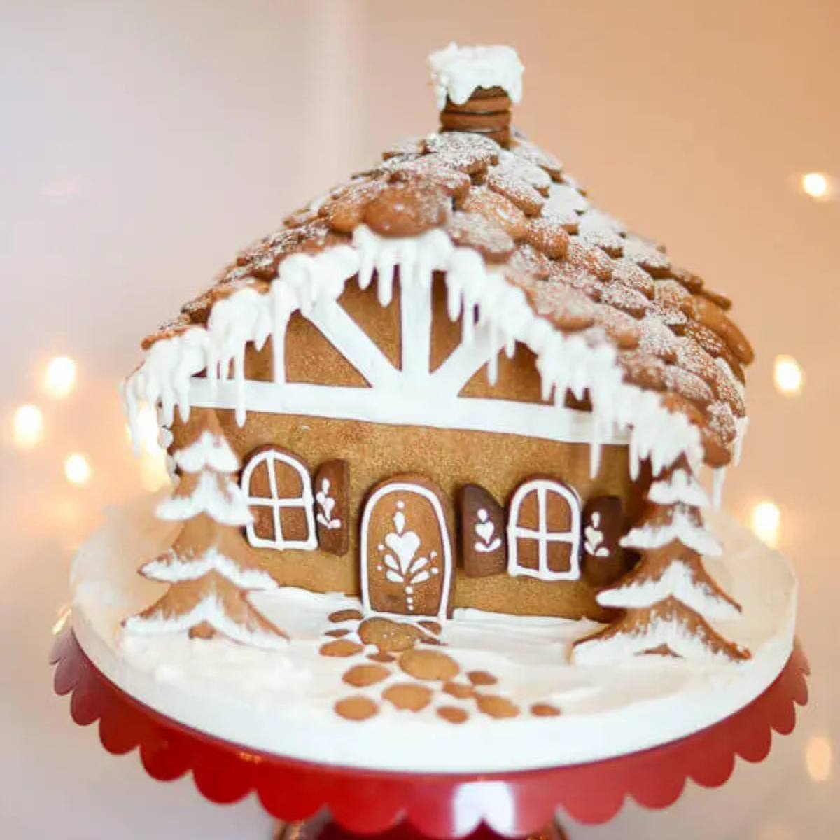 A beautifully decorated gingerbread house with a snowy roof, icing details, and candy decorations.