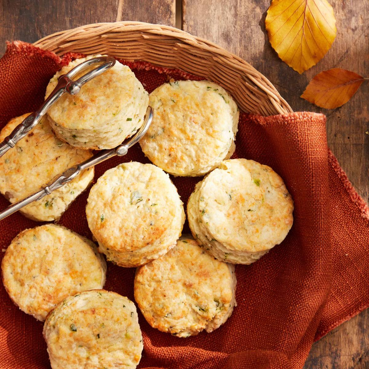 A basket filled with golden-brown biscuits, resting on a red cloth.