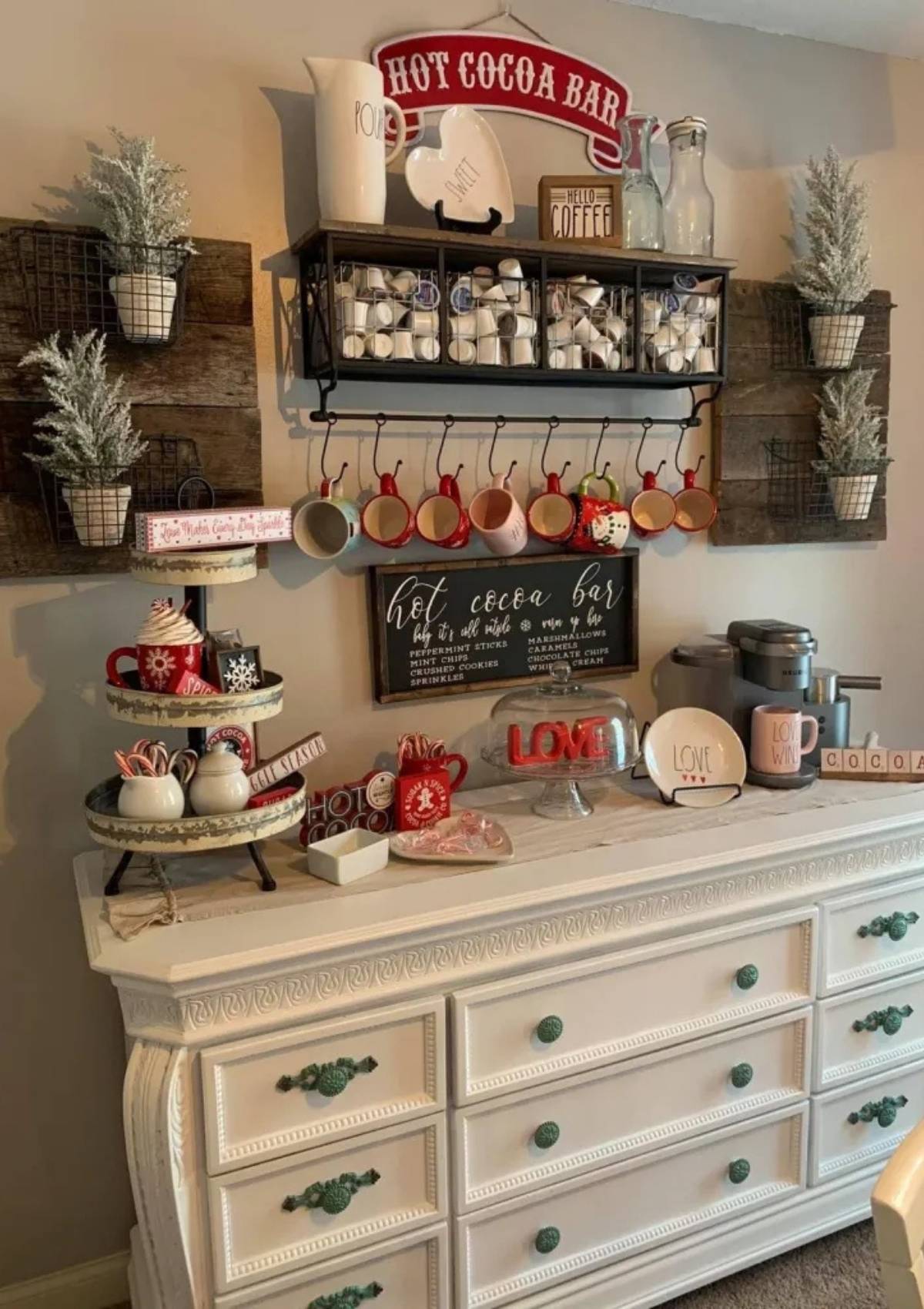 A festive hot cocoa bar with a variety of mugs, candy canes, and other decorations. There is also a sign that says "Hot Cocoa Bar".