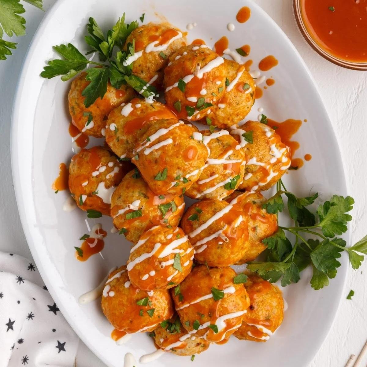 A platter of crispy, golden-brown Buffalo chicken meatballs. 