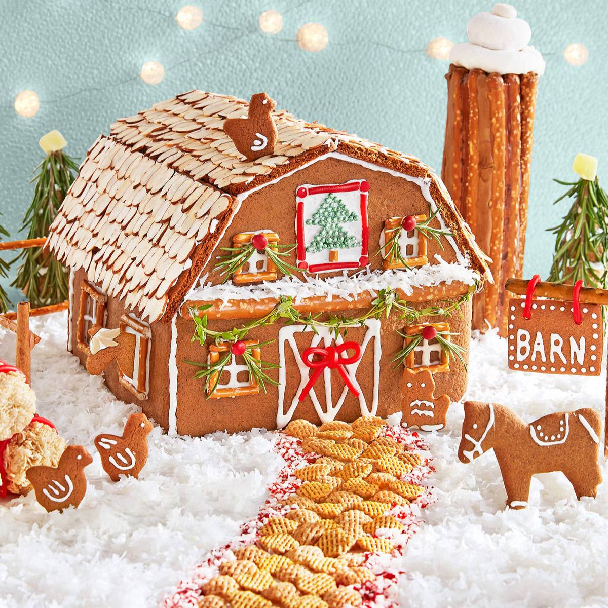 A whimsical gingerbread barn decorated with candy, surrounded by gingerbread animals and a pretzel pathway.