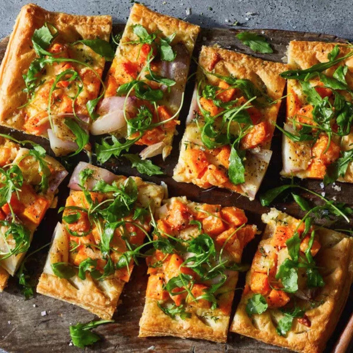 A rustic tart with a flaky crust, filled with roasted butternut squash, caramelized onions, and fresh herbs.