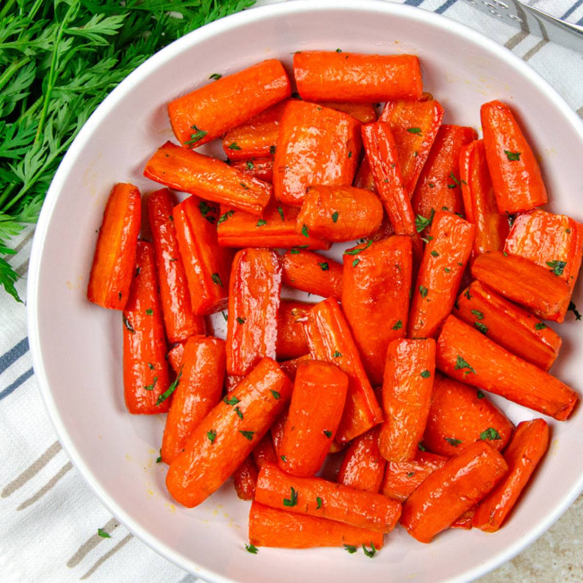 A bowl of glazed carrots, a popular side dish with a bright orange color and a sweet glaze.