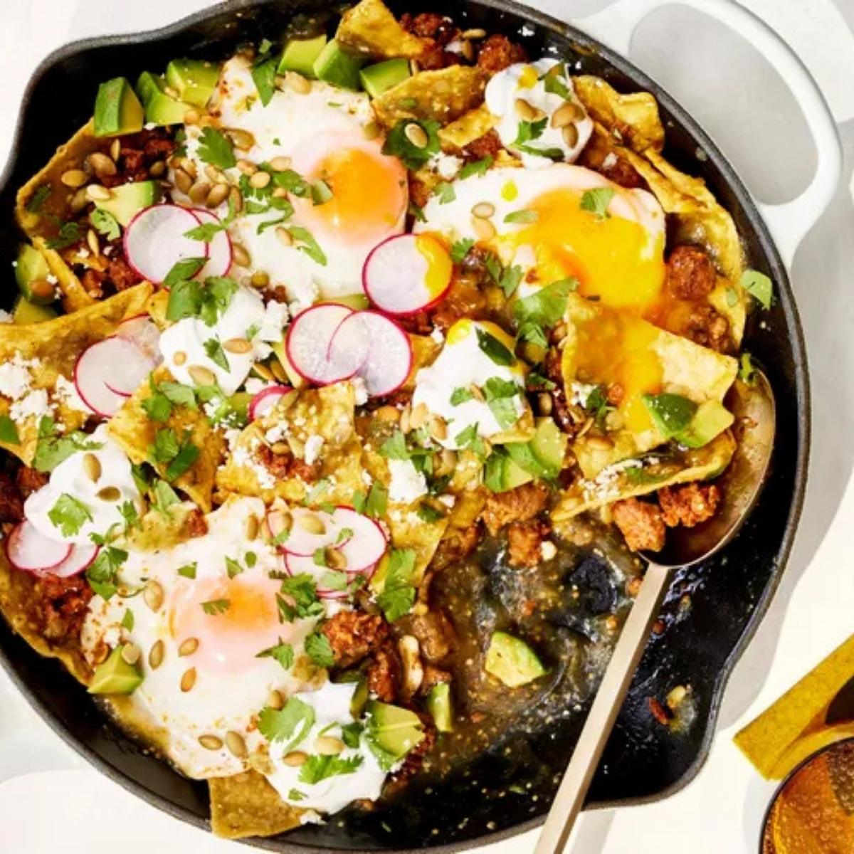 A skillet filled with a vibrant and delicious Chilaquiles dish.