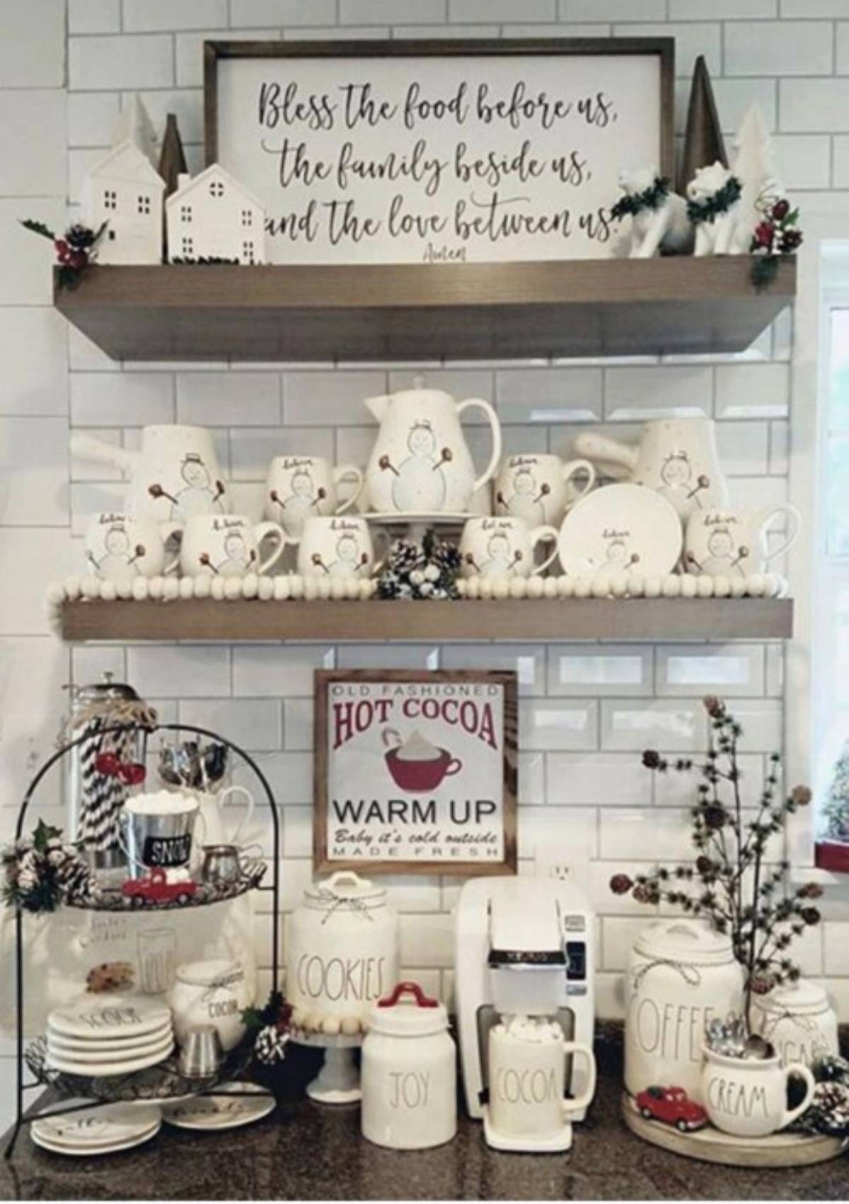 A festive hot cocoa bar with a variety of mugs, candy canes, and other decorations. There is also a sign that says "Old Fashioned Hot Cocoa".