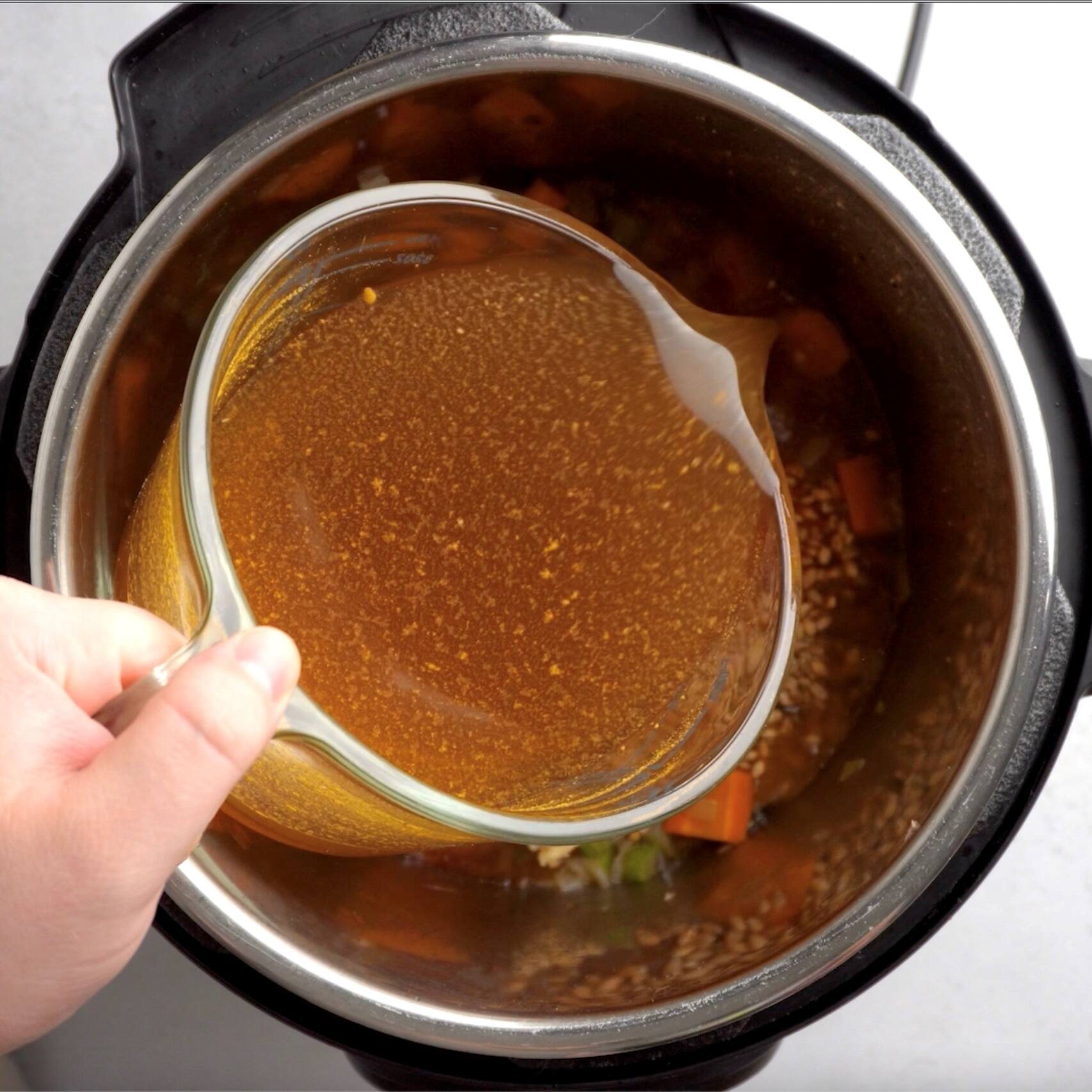adding broth to instant pot
