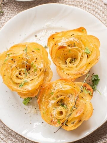 three air fryer potato roses on a white plate