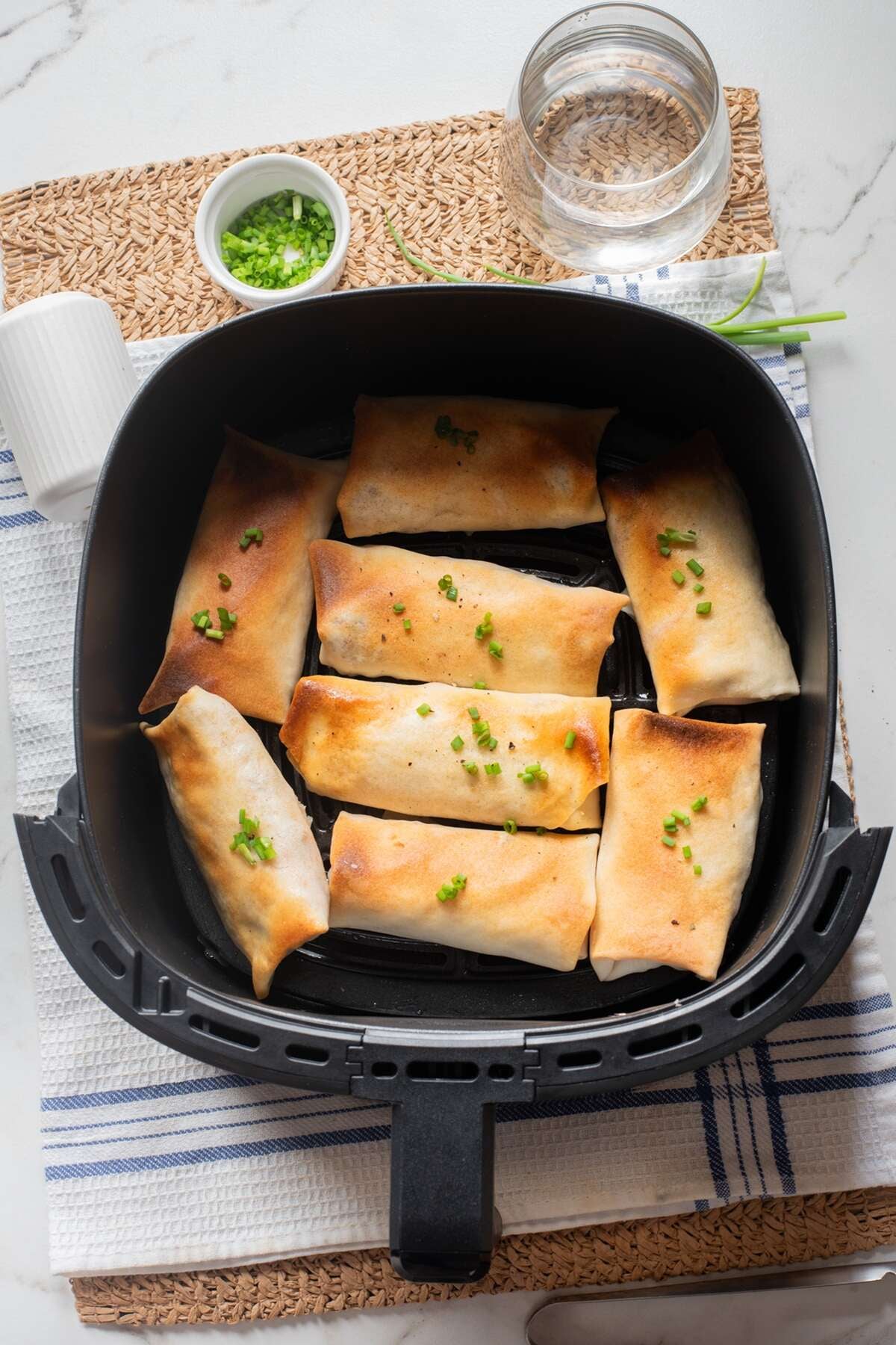 Lightly spray the egg rolls with oil and place seam-side down in the basket.