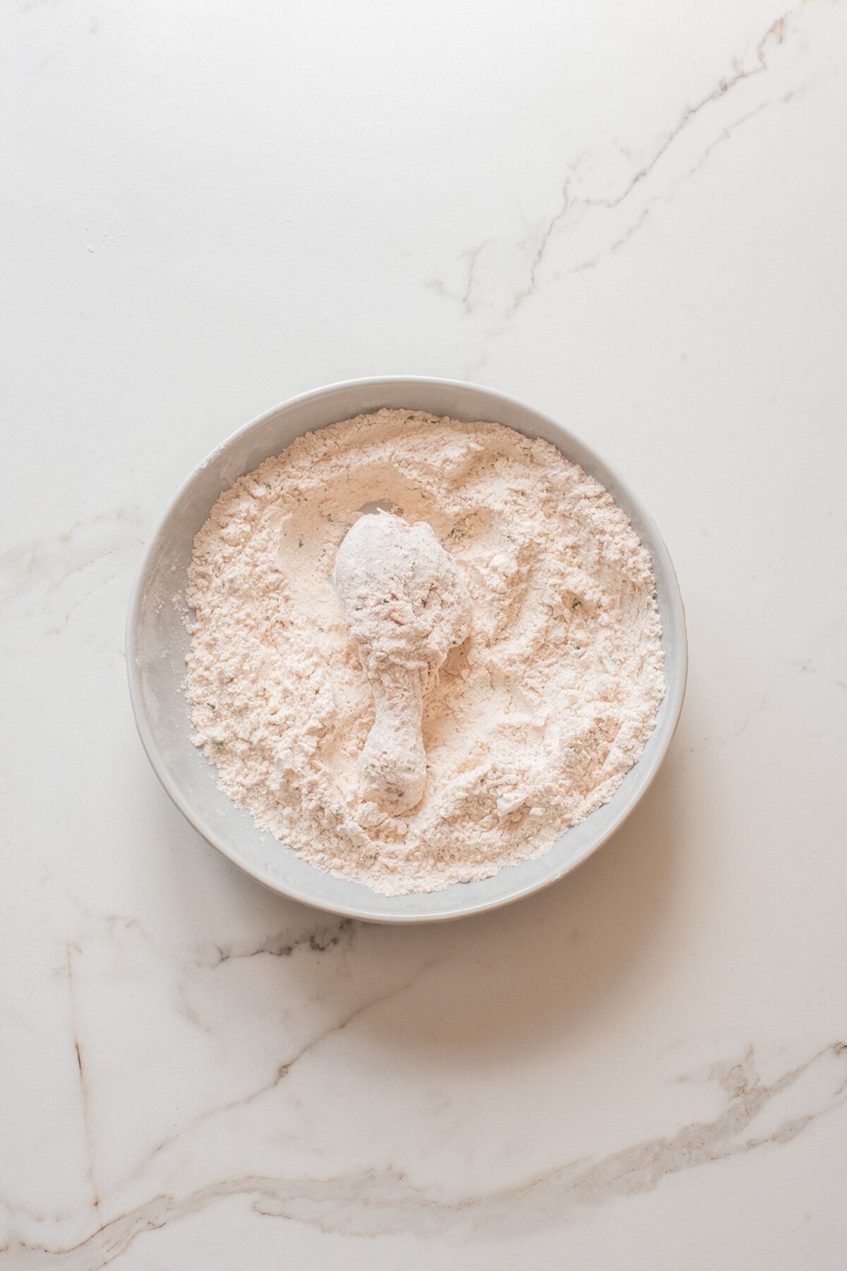 press the chicken into the seasoned flour