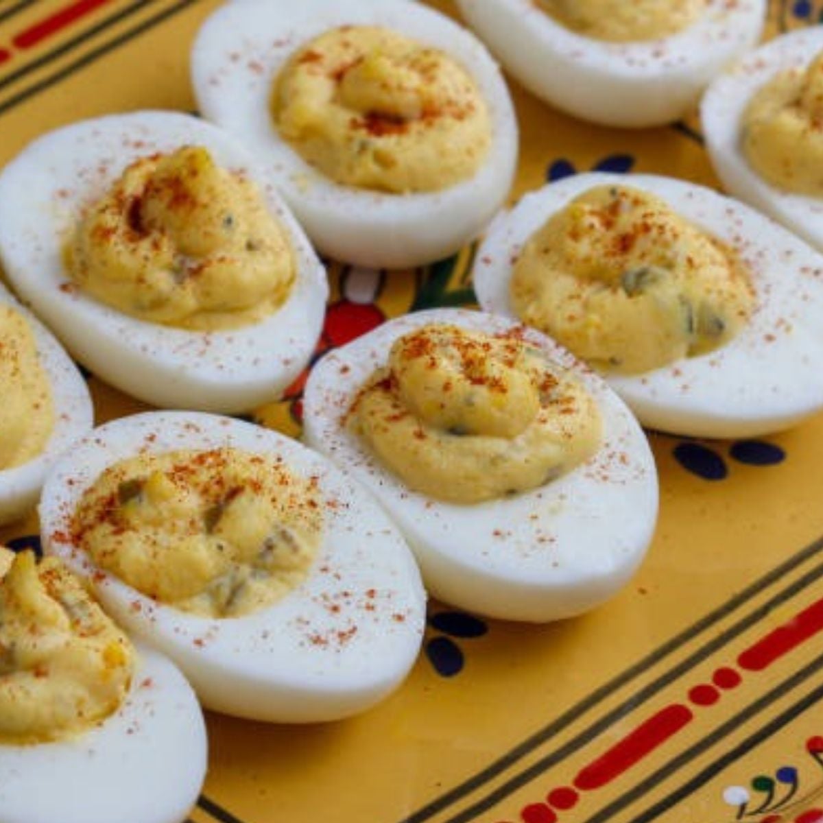 platter of deviled eggs with a creamy filling and some spices sprinkled over the top