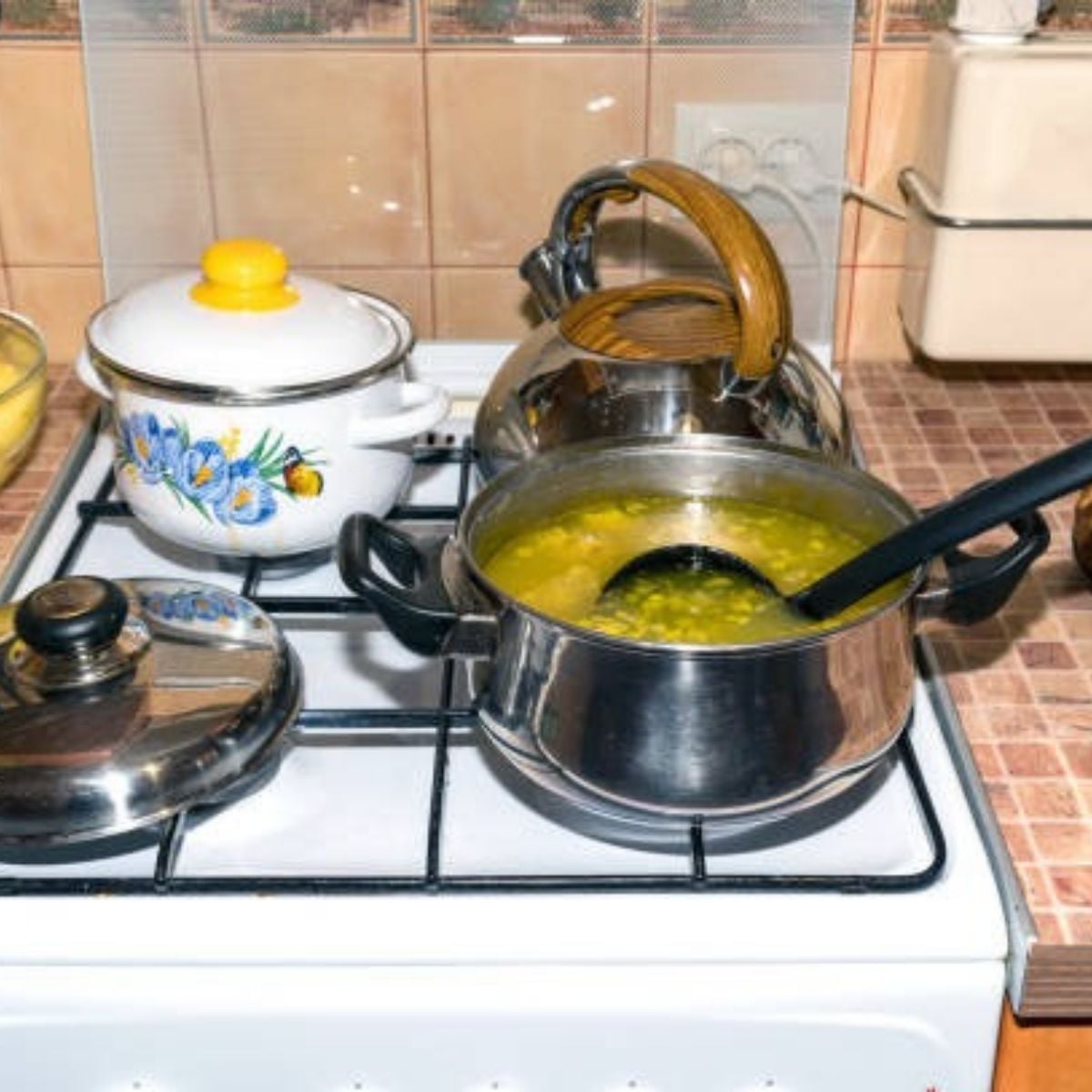 Soup Pot Left on the Stove with an open lid and a ladle inside.