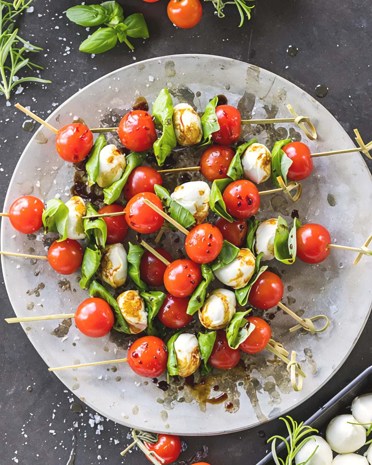 Fresh Caprese salad skewers layered with cherry tomatoes, fresh mozzarella balls, and basil leaves drizzled with balsamic glaze, perfect as quick and easy last minute potluck ideas.