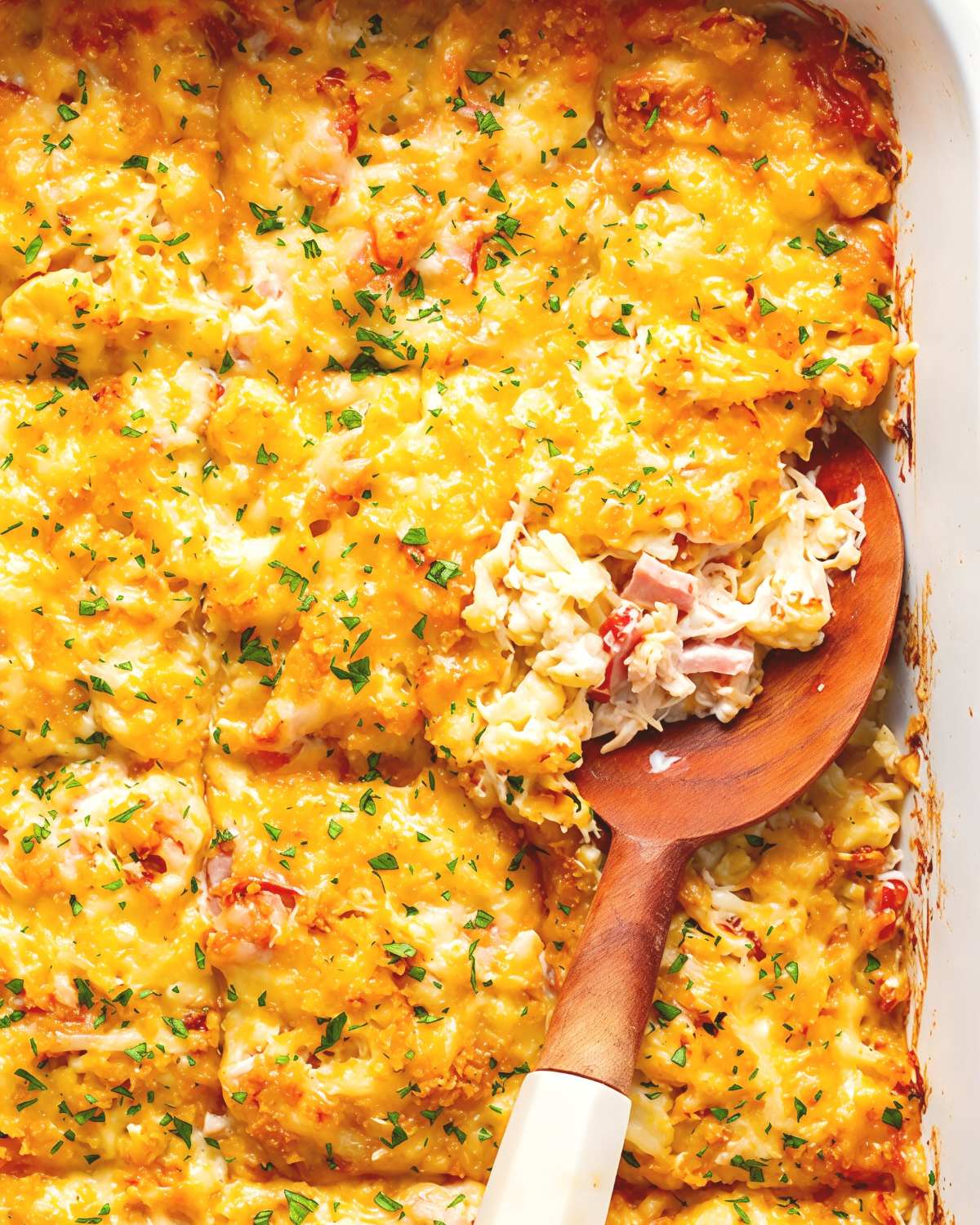Close-up view of a baking dish filled with cheesy Chicken Cordon Bleu Casserole featuring tender shredded chicken, diced ham, and melted cheese, featured as a delicious high protein low carb recipes dinner.