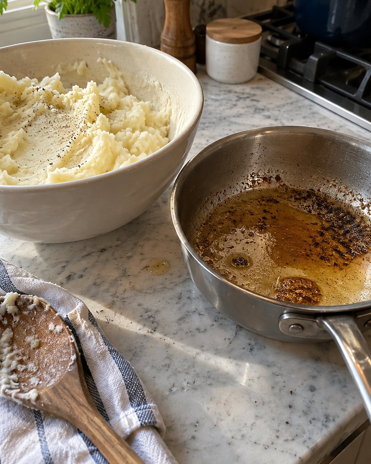 Brown butter in a small pan beside a bowl of mashed potatoes.