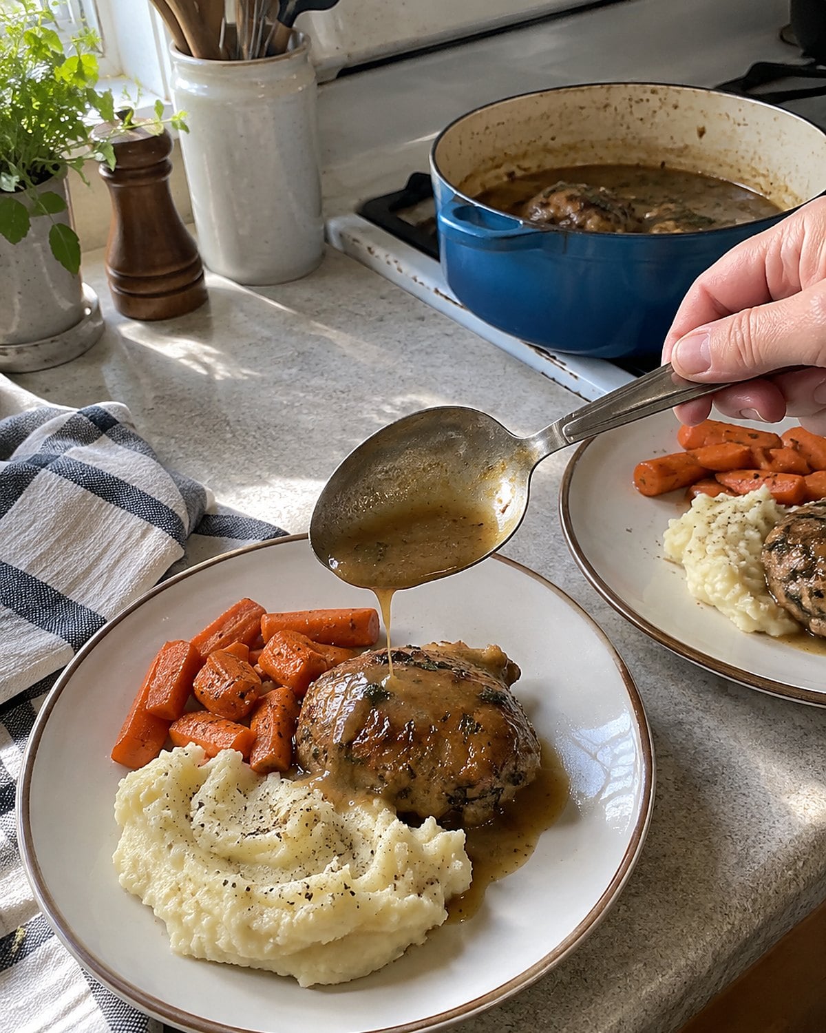 A woman's hand holds a worn serving spoon above two dinner plates beside the stove.