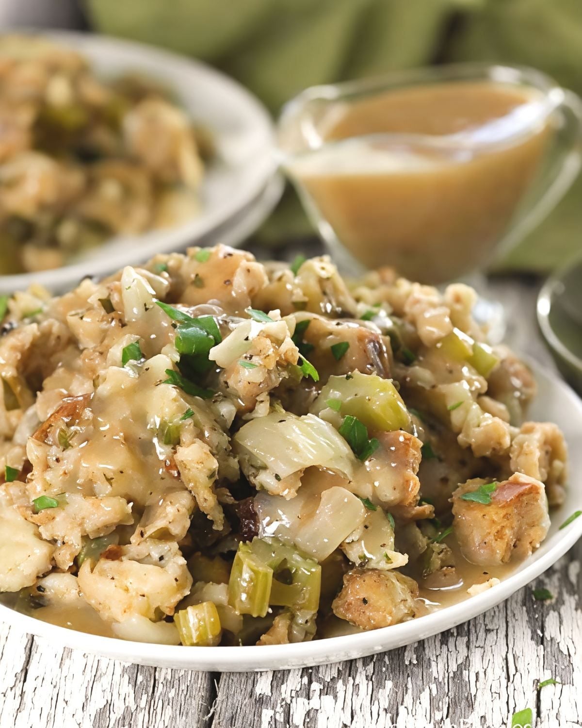A plate of savory slow-cooker crock pot stuffing drizzled with rich gravy, featured as a delicious option among crockpot thanksgiving sides.