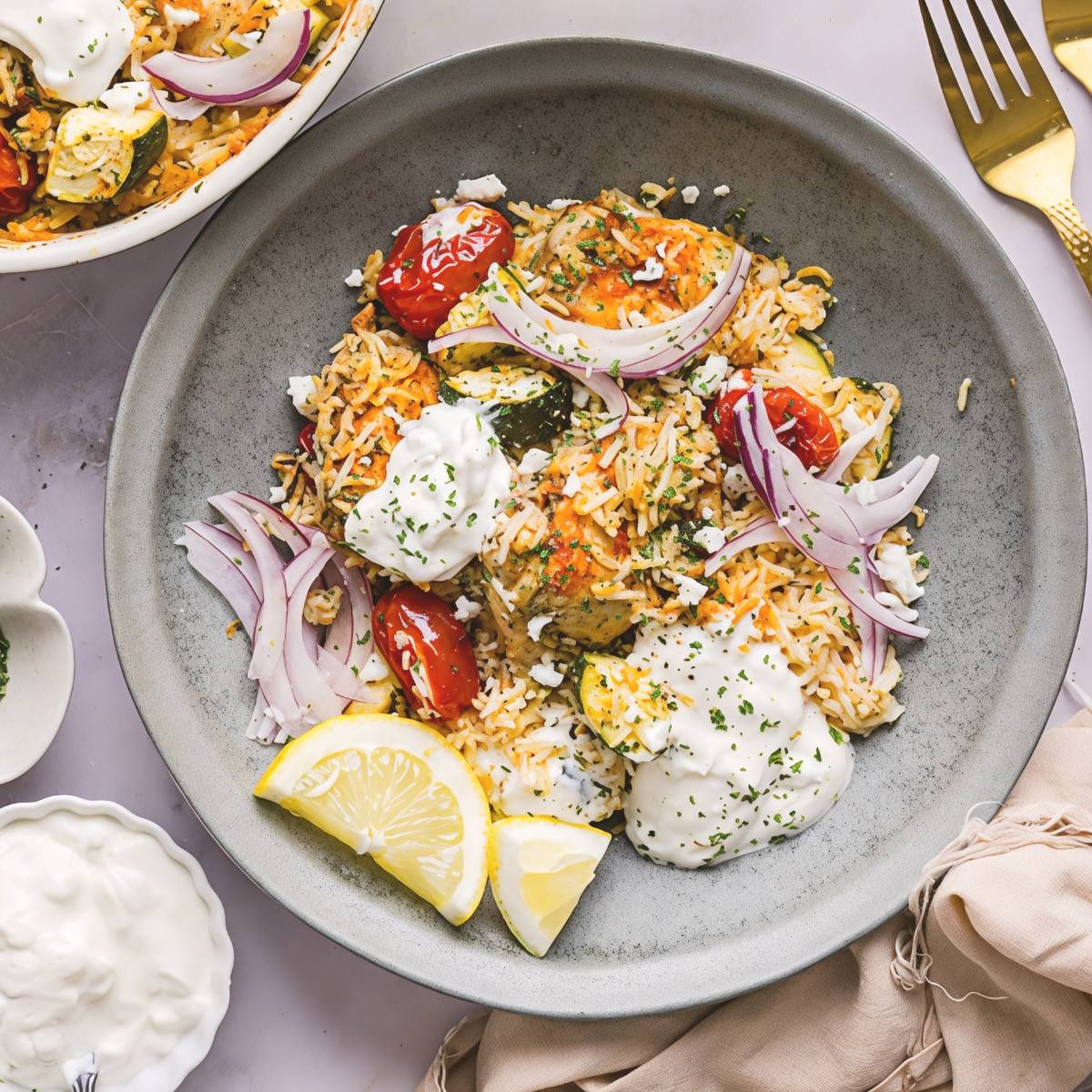 Greek chicken and rice casserole served in a bowl, a healthy dump and bake recipe for dinner.