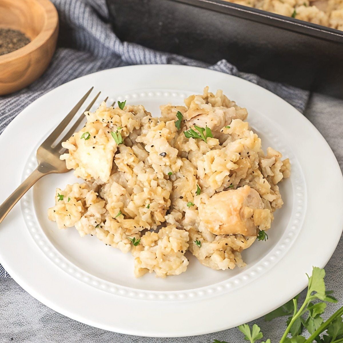 Easy chicken casserole served on a white plate, a comforting dump and bake recipe for dinner