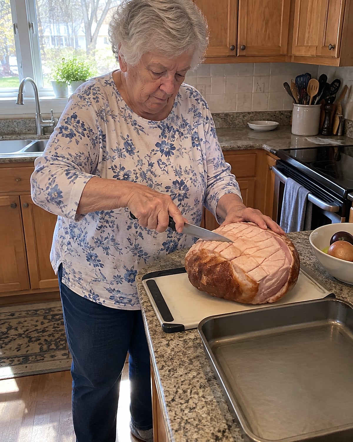 A hand scoring the fat of a ham in crossing lines beside an oven.