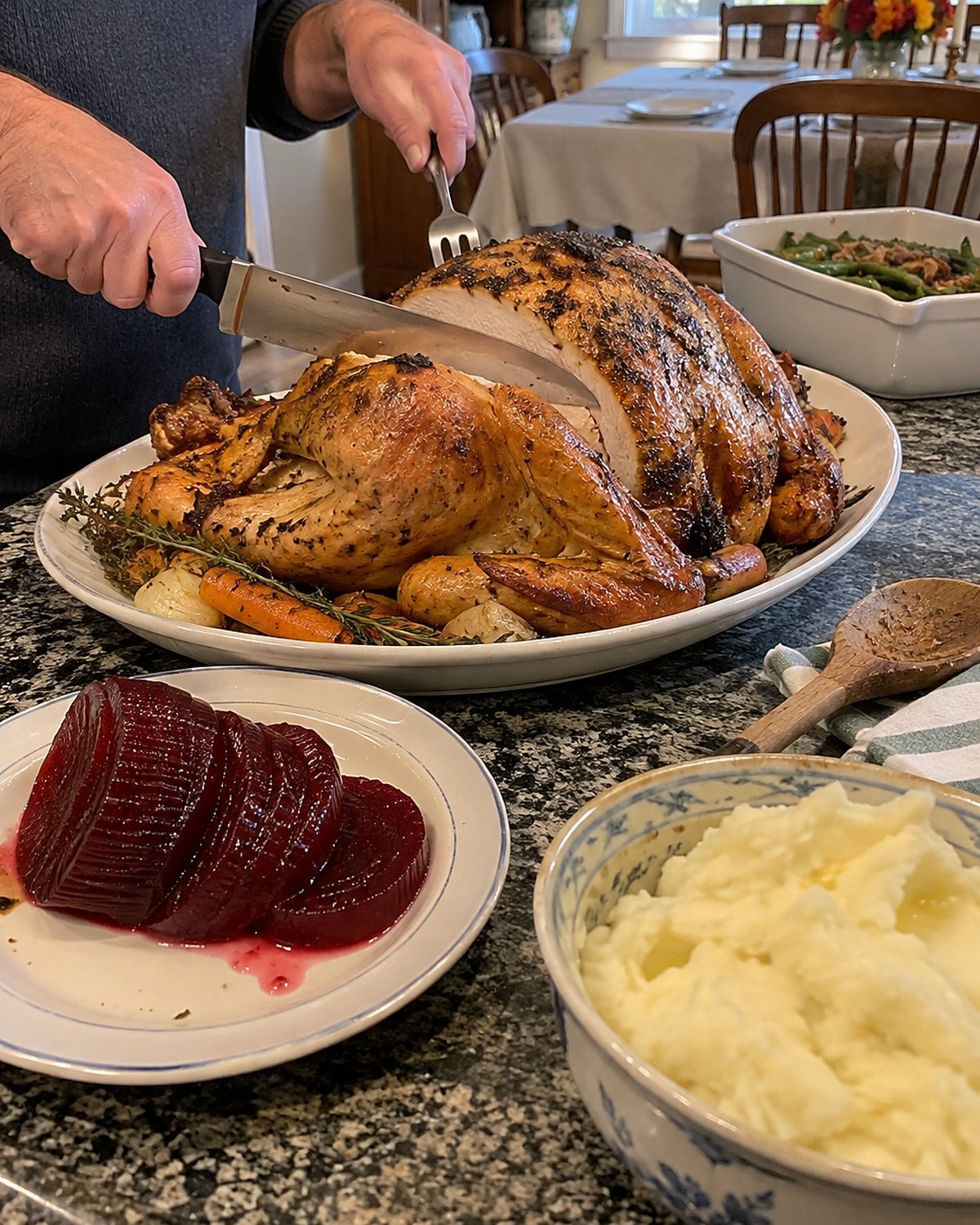 Ridged slices of canned cranberry sauce on a small plate beside a serving platter.