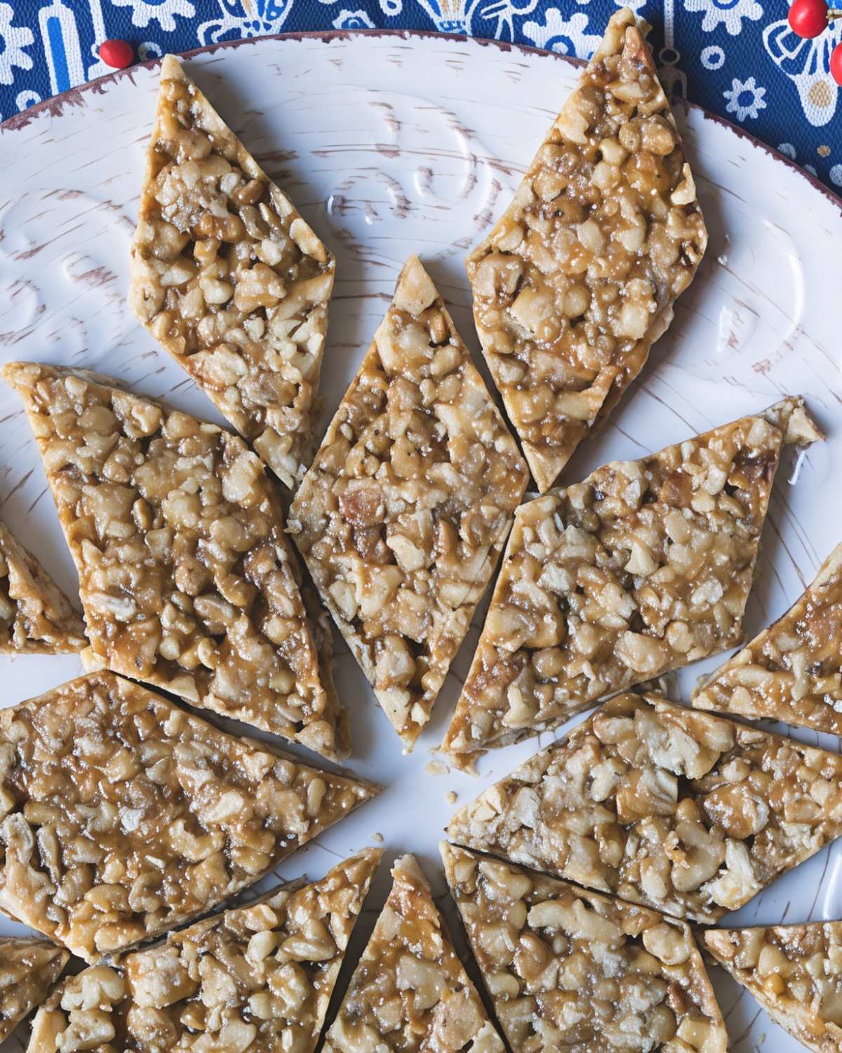 A flat-lay view of diamond-cut traditional Georgian Gozinaki, a honey and walnut brittle, as one of the best Christmas desserts of Europe.