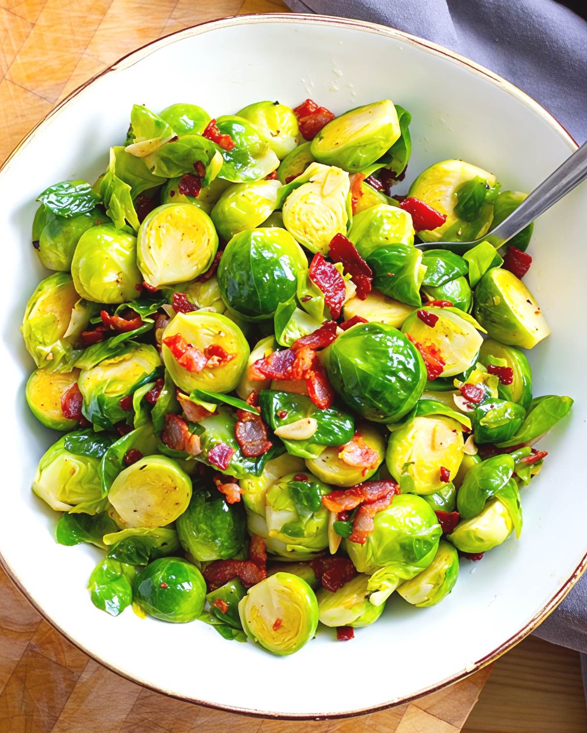 A white bowl of tender Instant Pot brussels sprouts tossed with crispy bacon and garlic, served as one of the best gluten-free Thanksgiving side dishes.