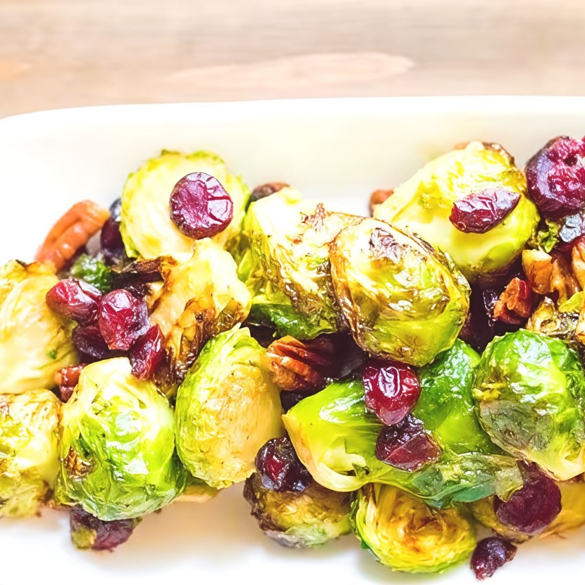 Roasted Brussels sprouts tossed with tart cranberries and crunchy pecans create a delicious dish for keto thanksgiving sides.