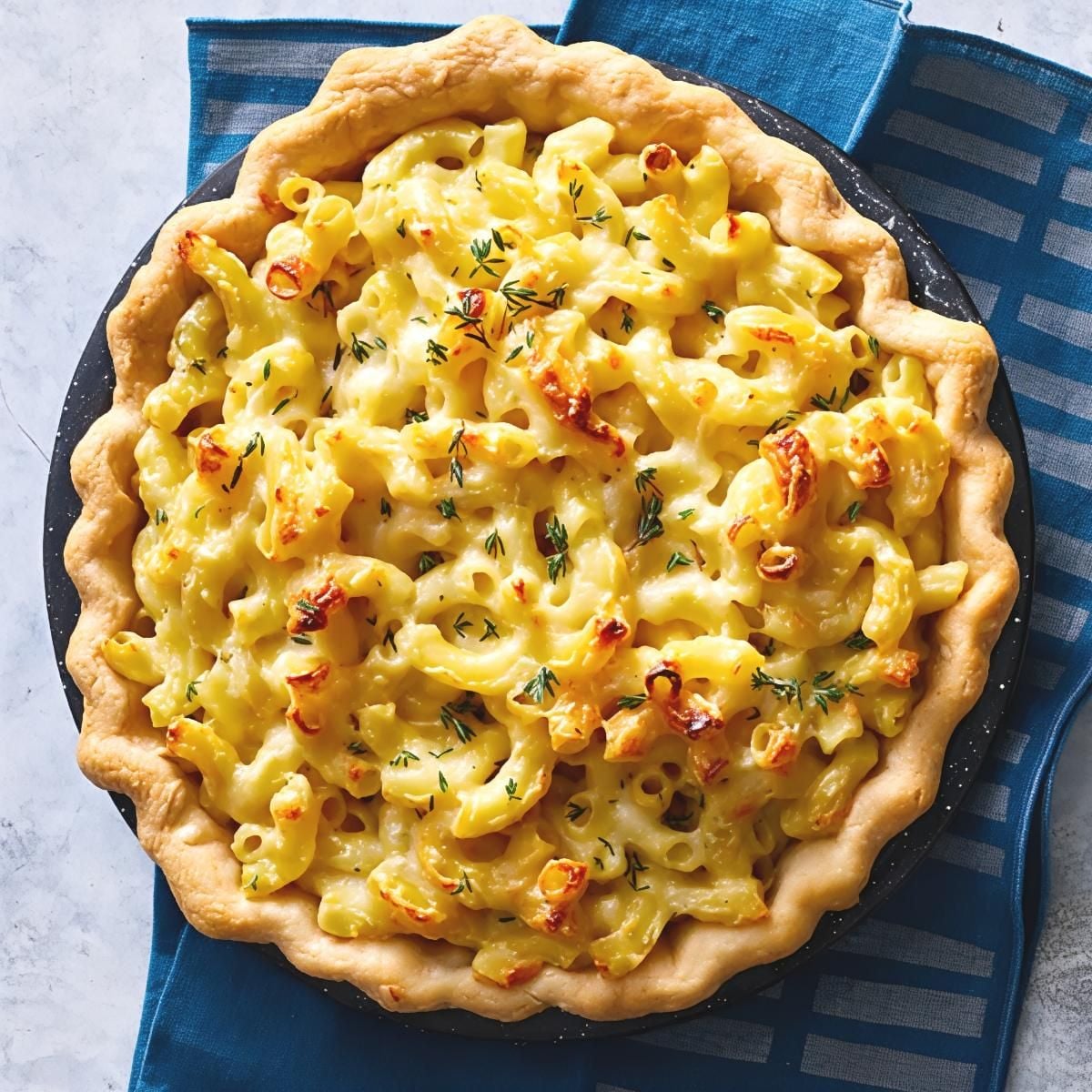 Homemade macaroni pie baked in a flaky crust with a creamy cheese filling and fresh herbs as a Southern Thanksgiving side dish.