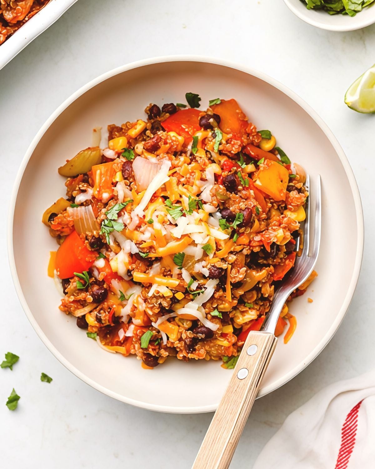 Mexican stuffed pepper casserole dump-and-bake recipe served in a bowl with melted cheese and fresh herbs.